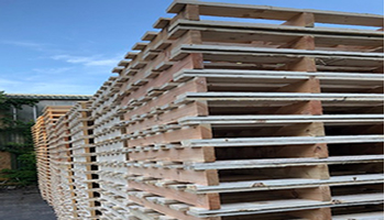 Stacks of two way entry wooden pallets manufactured in the UK